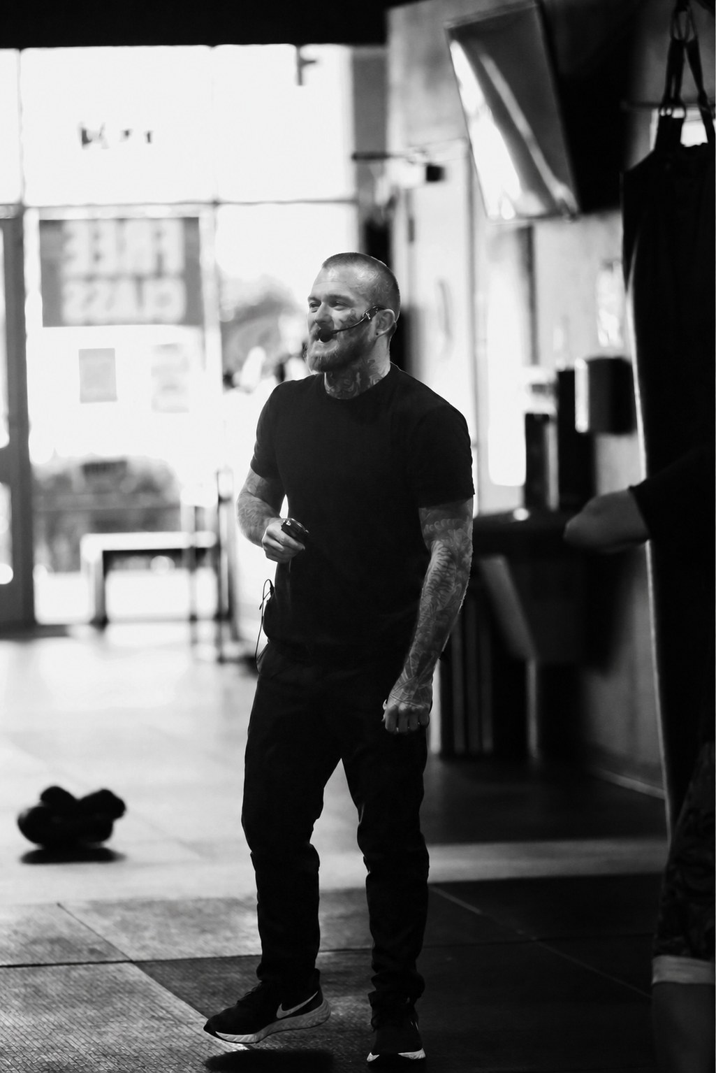 Shaun Anderson coaching in the gym, black and white candid photo