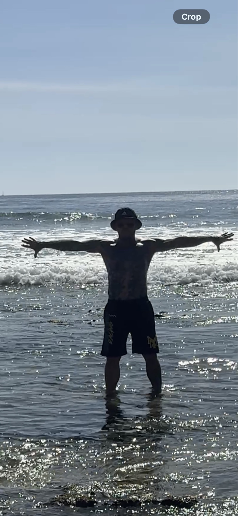 Shaun Anderson silhouetted practicing Korean Tai Chi at Laguna Beach, arms outstretched